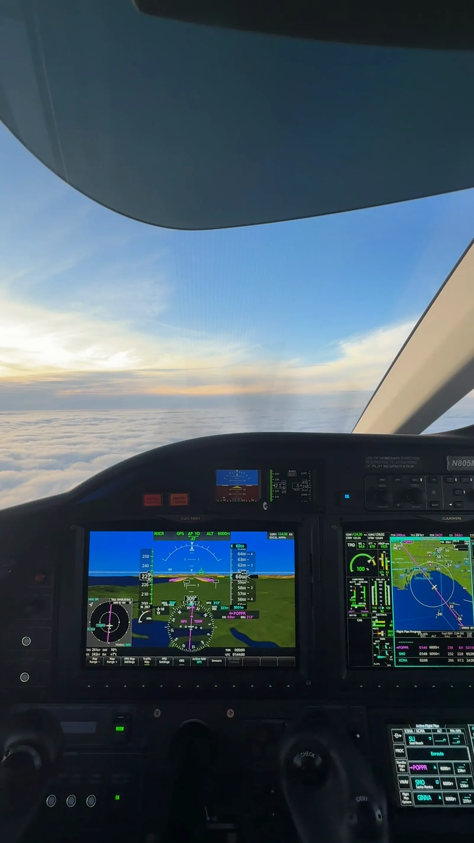 Cockpit view above a layer of clouds.